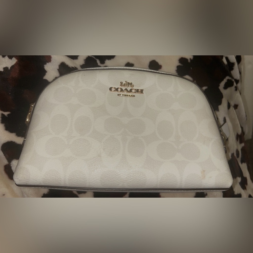 Coach cosmetic bag with minor stains see photos above.